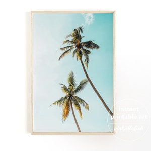 May include: A printable art print featuring two palm trees against a blue sky. The print has a white frame and the text "instant printable art pinkystylish" in the bottom right corner.