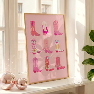 May include: A framed print featuring nine colorful cowboy boots in shades of pink, red, and white, set against a soft pink background. The boots showcase various designs and patterns, creating a vibrant and stylish artwork.