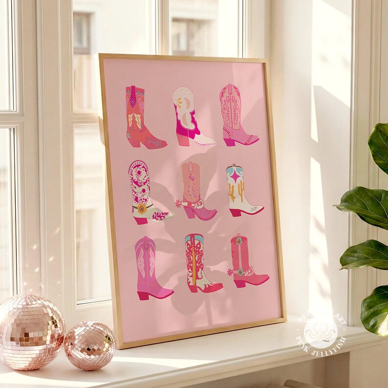 May include: A framed print featuring nine colorful cowboy boots in shades of pink, red, and white, set against a soft pink background. The boots showcase various designs and patterns, creating a vibrant and stylish artwork.