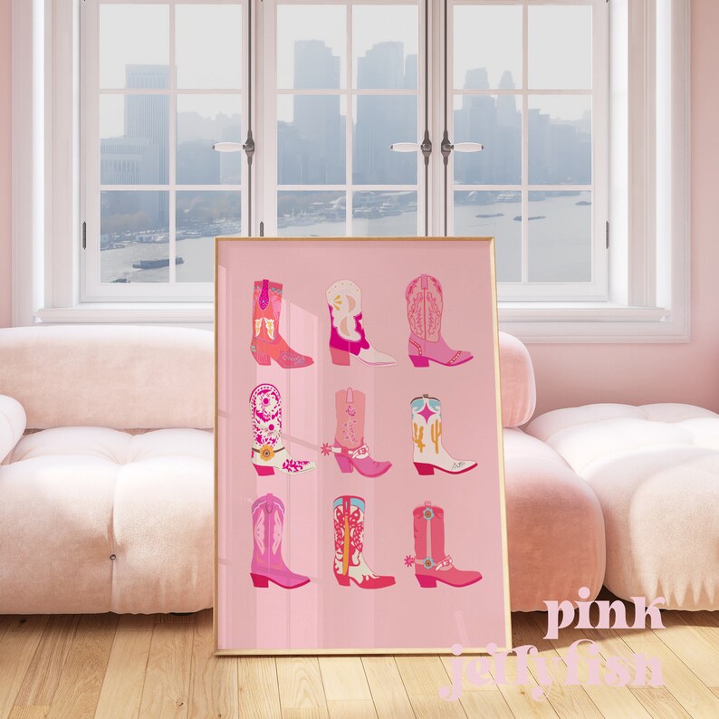 May include: A framed pink print featuring nine colorful cowboy boots in various designs. The boots are in shades of pink, orange, white, and blue. The word "pink" and "jellyfish" are written in white script at the bottom of the print.