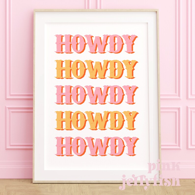 May include: A white framed print with the word "HOWDY" repeated five times in a stacked vertical design. The word is in a retro font with a pink and orange color scheme.