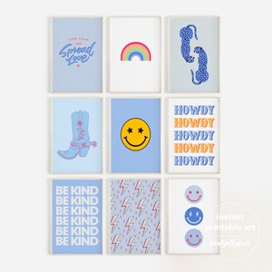 May include: Nine framed art prints with various designs. Prints include a rainbow, smiley faces, a cowboy boot, and text that reads "Keep Calm and Spread Love," "Howdy," and "Be Kind." The prints are in shades of blue, white, and orange.