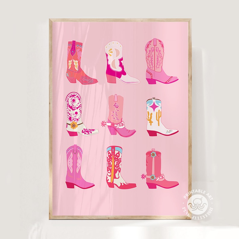 May include: A framed print featuring nine colorful cowboy boots in shades of pink, red, and white. The boots have various designs, including floral patterns and cacti, set against a light pink background. The artwork is in a vertical orientation.