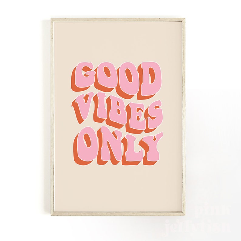 May include: A beige framed print with the text "GOOD VIBES ONLY" in pink and orange letters.