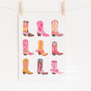 May include: A printable art print featuring nine colourful cowboy boots with different patterns and designs. The boots are arranged in three rows of three. The print has the text "instant printable art pinkjellyfish" at the bottom.