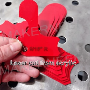 May include: A stack of red acrylic templates with rounded edges. The top template has a hole with a silver chain attached and the text "9/16" R" printed on it. The text "Laser cut from acrylic" is printed below the stack of templates.