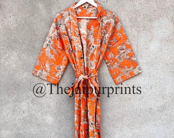 May include: An orange floral print robe with a matching tie, hanging on a white hanger. The robe features a botanical design in shades of beige and white. The text "@thejaipurprints" is visible on the bottom of the robe.