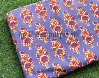 May include: Purple cotton fabric with a white background and a repeating pattern of orange, pink, and green floral paisley designs.