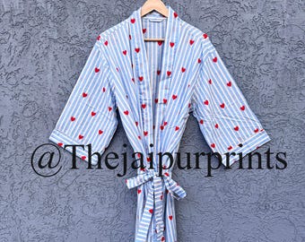 May include: A light blue and white striped robe with red heart accents. The robe has a matching belt and is hanging on a wooden hanger. The text "@thejaipurprints" is visible on the bottom left of the image.