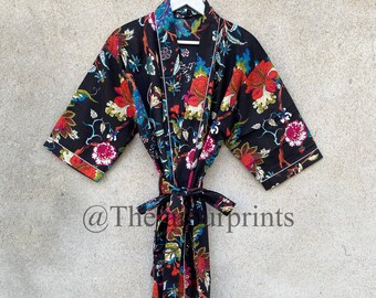 May include: A black floral print cotton robe with a white trim and a tie belt. The robe has a traditional Japanese kimono style.
