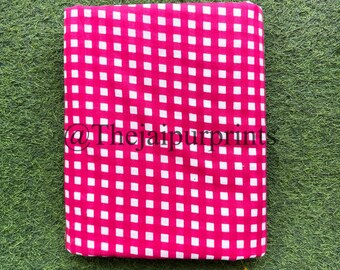 May include: Pink and white gingham fabric with a white square pattern on a pink background.