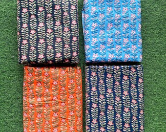 May include: Four fabric swatches with a floral print. The swatches are in black, blue, orange, and navy blue.