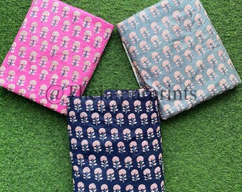 May include: Three fabric swatches with a floral print. The swatches are pink, blue, and gray. The flowers are pink and white.