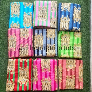 May include: Nine fabric swatches featuring a tiger print on a striped background. The stripes are in various colours, including pink, blue, green, red, and black. The tiger print is in a gold colour.
