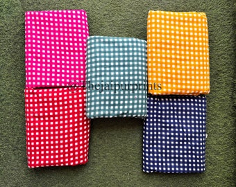 May include: Five fabric swatches with a gingham pattern. The swatches are in pink, red, green, yellow, and blue.