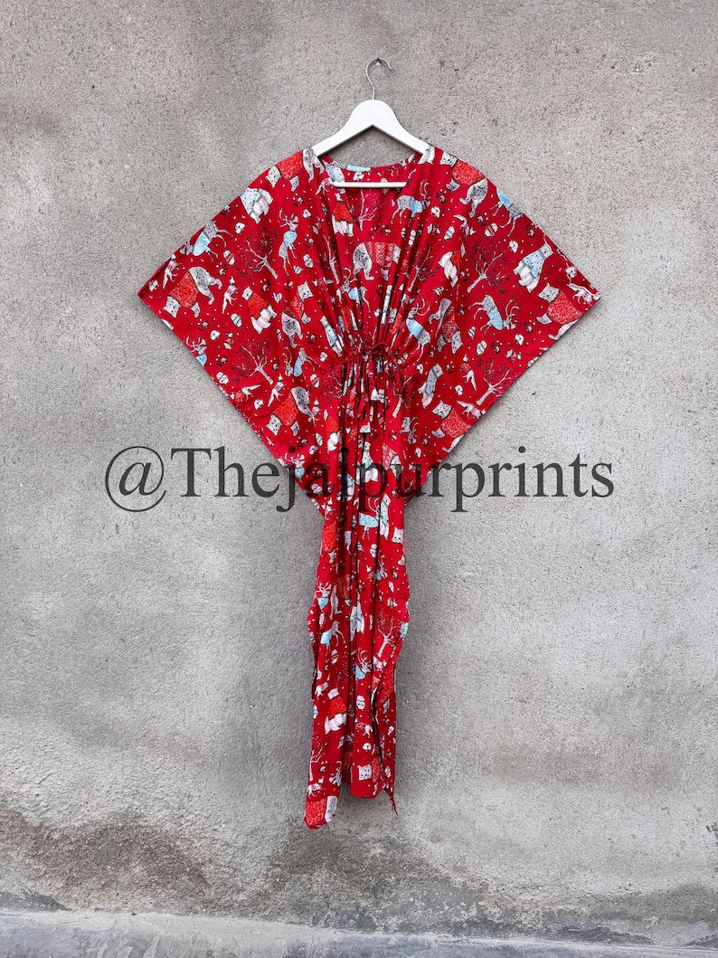 May include: Red kaftan with a white and blue animal print. The kaftan has a V-neck and a tie at the waist. The text "@TheJalpurprints" is visible in the bottom left corner of the image.