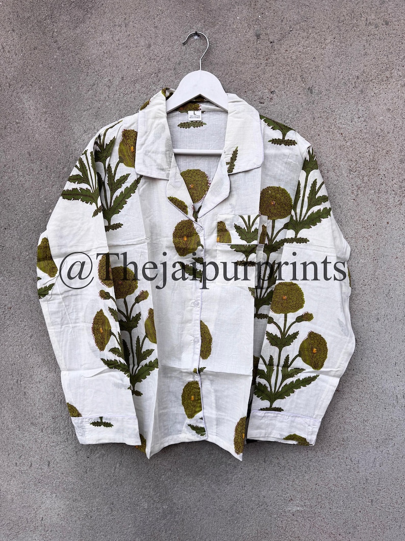 May include: White button-down pajama set with a green floral pattern. The long-sleeved shirt has a notched collar, a chest pocket, and the text "@Thejaipurprints". The floral design features large, round flowers and leafy stems.