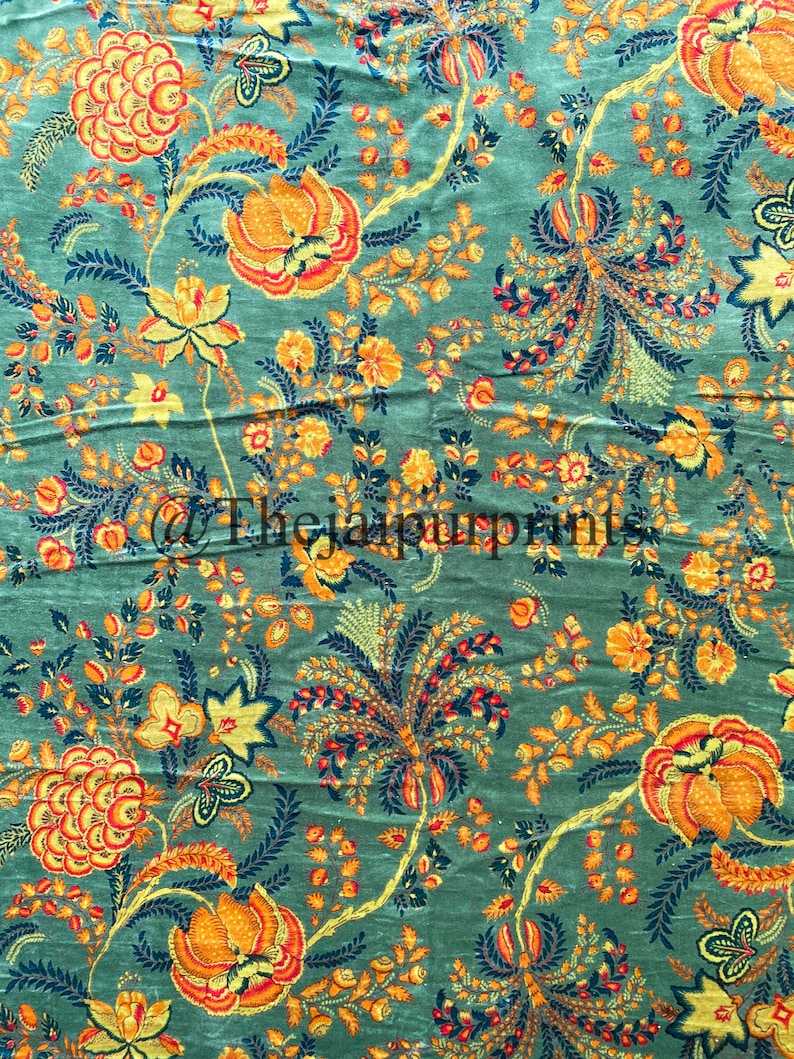 May include: A teal fabric with a floral pattern in shades of yellow, orange, and red. The flowers are stylized and have a vintage feel.