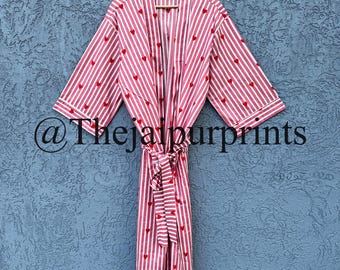 May include: A pink and white striped robe with red heart accents and a matching belt. The robe has a relaxed fit with wide sleeves and white trim. The text "@Thejaipurprints" is visible on the bottom left.