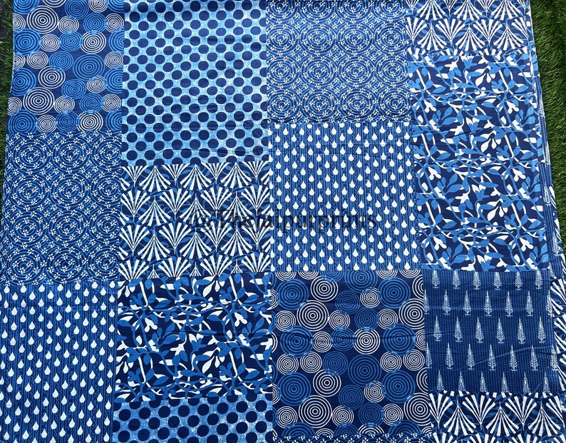 May include: Blue and white patchwork fabric with various patterns including circles, leaves, and geometric designs.