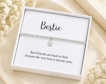 May include: A silver beaded stretch bracelet with a small star-shaped charm featuring clear stones. The bracelet is presented in a white gift box with the text Bestie and Best Friends are hard to find, because the very best is already mine.