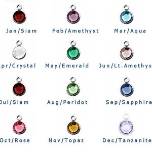 May include: Twelve round gemstone charms, each representing a different month of the year. The charms are silver with a variety of colored gemstones, including red, purple, blue, green, white, and pink.