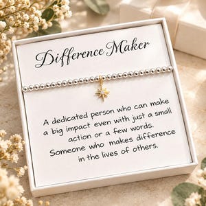 May include: A silver beaded bracelet with a gold-toned star charm featuring a small clear stone, presented in a white gift box. The card inside reads: Difference Maker, A dedicated person who can make a big impact even with just a small action or a few words. Someone who makes difference in the lives of others.