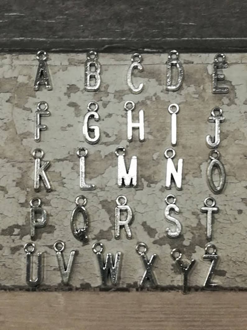 Pu&ograve; includere: Ciondoli in argento con lettere dell'alfabeto, dalla A alla Z, per la creazione di gioielli o progetti di artigianato.