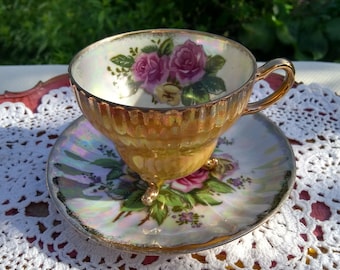 Lusterware footed yellow/cream/gold teacup decorated with roses.