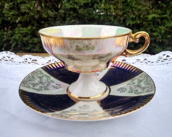 Beautiful white/blue footed  lusterware teacup and saucer decorated with gold decorations