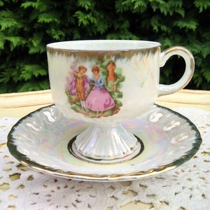 Lovely cream/gold lusterware vintage teacup and saucer decorated with fragonard decor