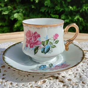 Lovely white/gold teacup and saucer decorated with pink roses