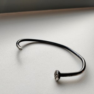 Nail. Men's silver cuff bracelet.