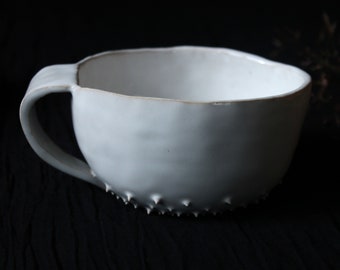 white ceramic cup made with spikes spiked cup mug