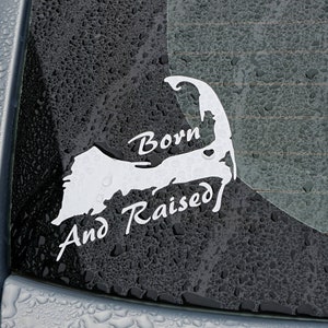 May include: A white vinyl sticker on a car window with a silhouette of Cape Cod and the text "Born and Raised".