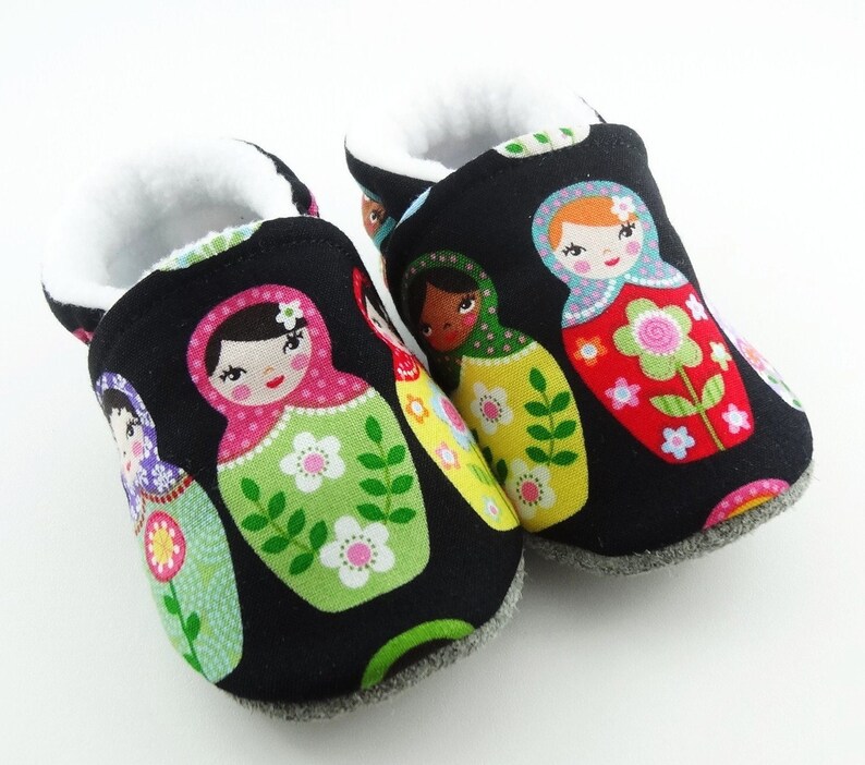 Baby leather sole and black cotton top shoes with matriochkas ideal for a birth gift