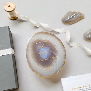 Gold calligraphy with monogram whew and gray agate slice wedding invitation, save the date, with box, silk ribbon, details card, and two place cards in the background