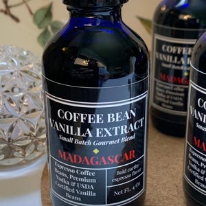 May include: A 4-ounce bottle of coffee bean vanilla extract with a black label that reads "Coffee Bean Vanilla Extract, Small Batch Gourmet Blend, Madagascar, Espresso Coffee Beans, Premium Vodka & USDA Certified Vanilla Beans, Bold Earthy Espresso Flavor, Net FL. 4 Oz."