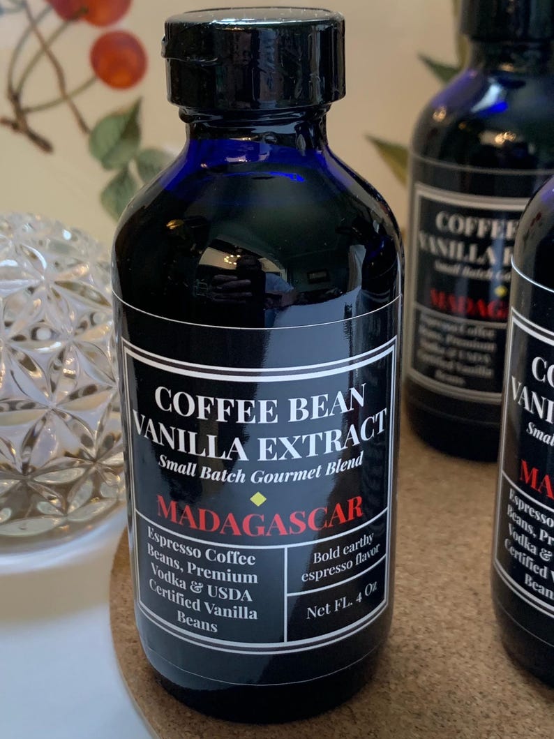 May include: A 4-ounce bottle of coffee bean vanilla extract with a black label that reads "Coffee Bean Vanilla Extract, Small Batch Gourmet Blend, Madagascar, Espresso Coffee Beans, Premium Vodka & USDA Certified Vanilla Beans, Bold Earthy Espresso Flavor, Net FL. 4 Oz."