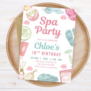 May include: A watercolor-style invitation for a spa-themed birthday party. The invitation features the text "Spa Party" in pink, with spa-related illustrations like a jade roller, eye mask, and cucumber slices. The invitation is on a wooden tray.