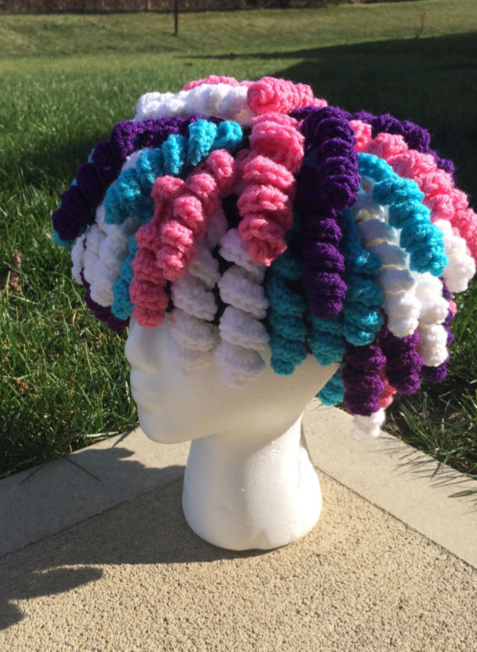 Crochet Curly Q Wig Pattern Colorful crochet curly wig with bouncy yarn curls, fun costume accessory for kids or adults, great for dress-up or Halloween.