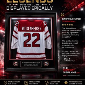 May include: Framed hockey jersey with the name "Wickenheiser" and the number "22" displayed. The jersey is white with red accents and is encased in a black frame. Text reads "Legends Deserve to be Displayed Epically."