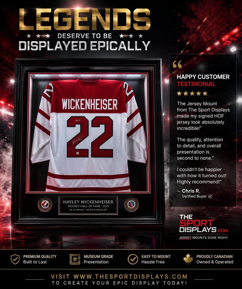 May include: Framed hockey jersey with the name "Wickenheiser" and the number "22" displayed. The jersey is white with red accents and is encased in a black frame. Text reads "Legends Deserve to be Displayed Epically."