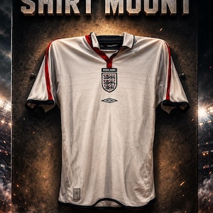 May include: A white soccer jersey with red accents and the England emblem, mounted on a textured surface. The text "SOCCER JERSEY SHIRT MOUNT" is displayed above the jersey. The website address is at the bottom.