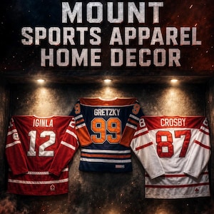 May include: Image featuring three hockey jerseys: Iginla #12 in red, Gretzky #99 in blue and orange, and Crosby #87 in white and red. Text at the top reads "JERSEY MOUNT SPORTS APPAREL HOME DECOR". The website address is www.thesportdisplays.com.