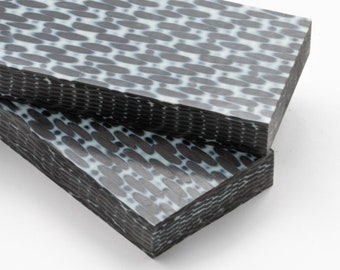 May include: Two black and white patterned rectangular slabs of material. The slabs have a textured surface and are stacked on top of each other.