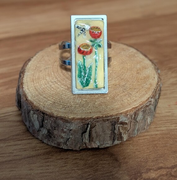 Red Morning Glories: Handmade jewelry- carved and painted clay and resin statement ring. Red flowers, green leaves, a dragonfly, on yellow.