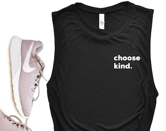 May include: Black sleeveless muscle tank top with the text "choose kind." printed in white on the front. The tank top is shown with a pair of pink running shoes.
