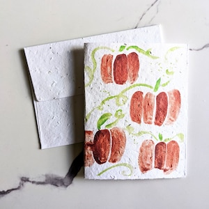 Carte d'automne automne, citrouilles sur papier de graines à planter ou papier blanc aquarelle, Halloween