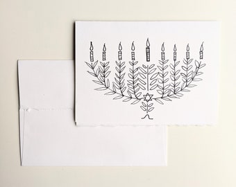 Happy Hanukah greeting card, black drawing on plantable seed paper or watercolor white paper, menorah with leafs